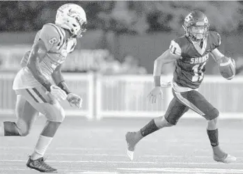  ?? JENNIFER LETT/SUN SENTINEL ?? University School QB Nick Vattiato rolls left during the second half of the game against American Heritage-Delray.