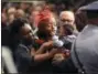  ?? PATRICK DENNIS — BATON ROUGE ADVOCATE VIA AP ?? Trenisha Jackson, widow of Baton Rouge police Cpl. Montrell Jackson, holds their child, Mason Jackson, as she arrives to view his casket Monday at the Living Faith Christian Center in Baton Rouge, La.