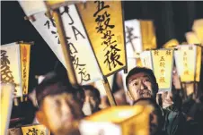  ?? ?? Men carry lanterns as they walk to a river to cleanse their bodies during the Sominsai Festival at Kokuseki-ji Temple in Oshu, Iwate Prefecture, Japan.