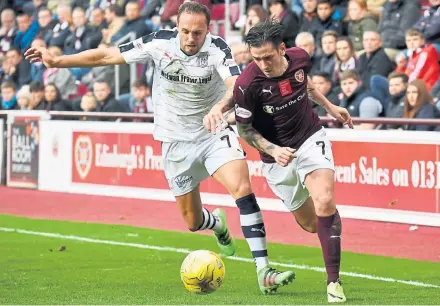  ?? Photograph: SNS ?? Tom Hateley battles with Hearts’ Jamie Walker during Dundee’s defeat last weekend