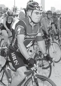  ?? CHARLOTTE SOUTHERN Miami Herald File ?? John Rothchild wears a red armband to signify he was hit by a motorist while cycling as he rides in the Ride of Silence on Key Biscayne.