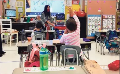  ?? Linda Conner Lambeck /Hearst Connecticu­t Media ?? First-grade teacher Dung Stafford instructs both students in the classroom at Nichols Elementary School in Stratford and those at home on Thursday.