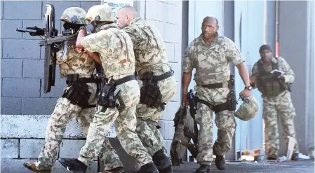  ?? PICTURE: PHANDO JIKELO ?? POUNCE: The police’s special task force made their way into the Shoprite store at Nyanga Junction yesterday following a 12-hour-long hostage drama.