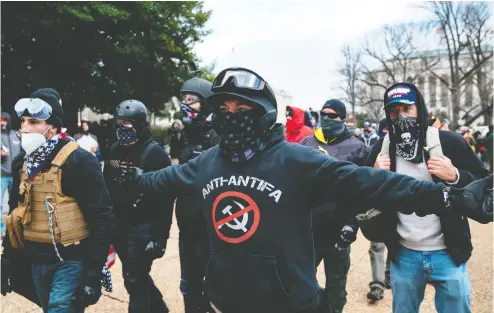  ?? ALEX EDELMAN / AFP via Gett y Images ?? A protester who claimed to be a member of the Proud Boys gathers with other supporters
of U. S. President Donald Trump outside the US Capitol on Wednesday.