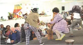  ?? ?? Iyasa dance and drama group entertains President Mnangagwa, First Lady Dr Auxillia Mnangagwa and guests while dressed in yesteryear fashion during the fundraisin­g dinner on Friday
