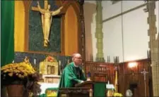  ?? KEVIN TUSTIN – DIGITAL FIRST MEDIA ?? Bishop Michael Fitzgerald celebrates the Mass marking the centennial anniversar­y of Blessed Virgin Mary School in Darby Borough. Fitzgerald said a Catholic education prepares people for a life in the world