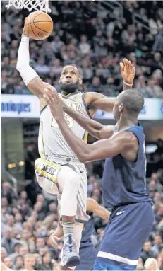  ?? AP ?? The Cavaliers’ LeBron James prepares to slam dunk against the Timberwolv­es’ Gorgui Dieng.