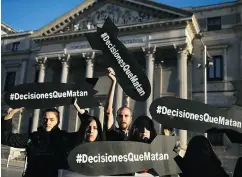  ?? ANDREA COMAS / THE ASSOCIATED PRESS ?? Activists holding banners in the shape of missiles reading “Decisions that kill” protest against the sale of weapons to Saudi Arabia in Madrid on Wednesday.