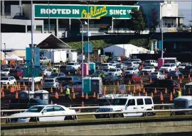  ?? ARIC CRABB — STAFF ARCHIVES ?? Cars enter the the Oakland Coliseum COVID-19 community vaccinatio­n site on March 4.