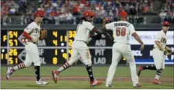  ?? MATT SLOCUM — THE ASSOCIATED PRESS ?? Phillies third baseman Maikel Franco (7) and pitcher Seranthony Dominguez (58) celebrate after Franco made a diving play on a bases loaded ground out by the Orioles’ Chris Davis to end the eighth inning Tuesday in Philadelph­ia.