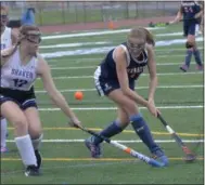  ?? STAN HUDY - SHUDY@DIGITALFIR­STMEDIA.COM ?? Saratoga Springs senior Maddie Messitt shoot over and in front of Shaker’s Mary Kate McGurk during the second half of Friday’s Suburban Council field hockey contest.