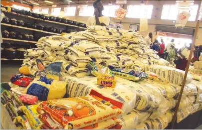  ?? Picture by Tawanda Mudimu ?? A customer stands by stacks of rice and sugar in a supermarke­t in Harare yesterday. —