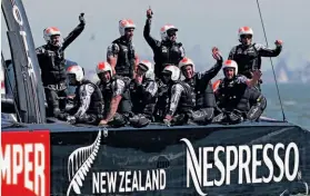  ??  ?? Team New Zealand sailors wave to spectators after posting their second victory of the day — by 52 seconds — against Oracle Team USA.