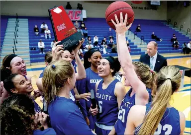  ?? Matthew Christense­n/JBU Sports Informatio­n ?? Oklahoma City players celebrate after winning the Sooner Athletic Conference Tournament on Saturday at Bill George Arena. The defending national champion Stars defeated Science and Arts 89-63.