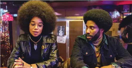  ??  ?? Laura Harrier as Patrice Dumas with John David Washington as Ron Stallworth