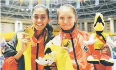  ??  ?? Rebecca (right) and Monica won Sarawak’s seventh and eighth gold medals on the final day of taekwondo competitio­n. — Photo by Teo Chi Wei