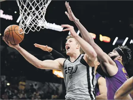  ?? Darren Abate Associated Press ?? JAKOB POELTL helped the Spurs outscore JaVale McGee and the Lakers by 23 in the fourth quarter, and beat them for the third time in four games. “Their second unit came in and gave them a lot of life in that fourth quarter and turned it around,” LeBron James said.