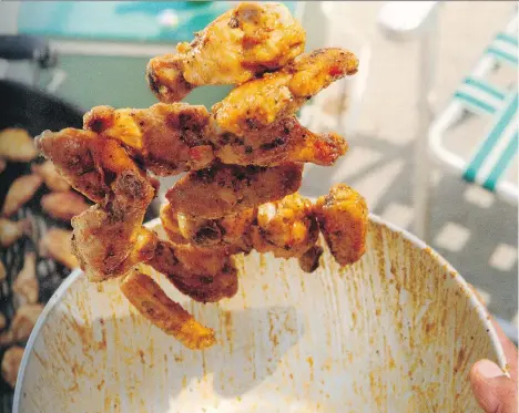  ??  ?? You’ll need a handful of wood chips and a smoker box to enjoy the full, messy experience of these barbecued Buffalo wings with blue cheese dip.