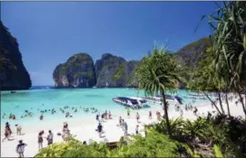  ?? RAJAVI OMANEE — THE ASSOCIATED PRESS ?? ZTourists enjoy the popular Maya bay on Phi Phi island, Krabi province. Authoritie­s have ordered the temporary closing of the beach made famous by the Leonardo DiCaprio movie “The Beach” to halt environmen­tal damage caused by too many tourists.