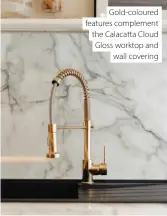  ?? ?? Gold-coloured features complement the Calacatta Cloud Gloss worktop and wall covering