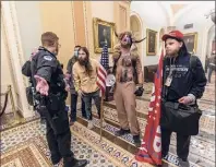  ?? Manuel Balce Ceneta / Associated Press ?? Supporters of President Donald Trump are confronted by Capitol Police officers outside the Senate Chamber inside the Capitol, on Wednesday in Washington.