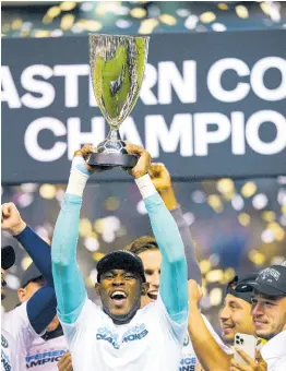  ?? AP ?? Philadelph­ia Union’s Andre Blake raises the trophy after his team defeated New York City FC in the MLS Eastern Conference final in 2022.