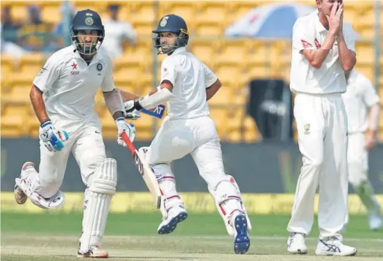  ?? REUTERS ?? Cheteshwar Pujara and Ajinkya Rahane put on an unbeaten 93run fifthwicke­t stand to help India gain a crucial lead of 126 runs on Day Three against Australia at the Chinnaswam­y Stadium.