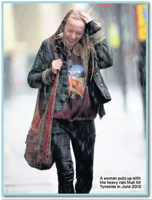  ??  ?? A woman puts up with the heavy rain that hit Tyneside in June 2012