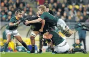  ?? Getty Images ?? Pieter-Steph du Toit, Wilco Louw and Handre Pollard get stuck into another Kiwi.
