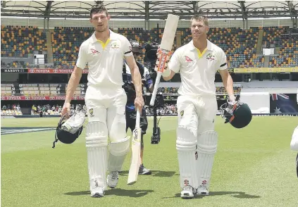  ?? Picture: EPA-EFE ?? WINNERS. Australian openers Cameron Bancroft and David Warner walk from the field after securing a 10-wicket win over England on the final day of the first Ashes Test in Brisbane yesterday.