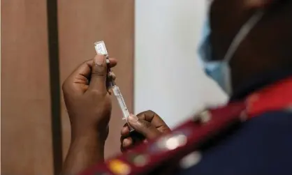  ?? Photograph: Siphiwe Sibeko/Reuters ?? A medical worker prepares a Covid-19 vaccine in Dutywa, South Africa.