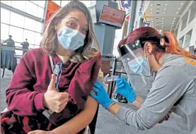  ?? Matt stone pHotos / boston Herald ?? Juliana White, a nursing student at simmons University, gets her coVid-19 vaccine from Kristen pina at the cic Health vaccinatio­n site at Gillette stadium in Foxboro on monday.