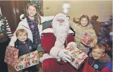  ??  ?? Father Christmas with Ronan and Orlan Woodward and Ben and Elizabeth Pugh