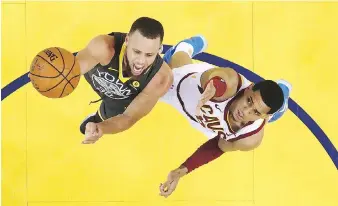  ?? EZRA SHAW/THE ASSOCIATED PRESS ?? Golden State point guard Stephen Curry drives for a layup against Cleveland Cavaliers counterpar­t Jordan Clarkson during Game 2 of the NBA Finals on Sunday. The Warriors won 122-103.