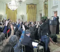  ?? AP ?? FIGHTING WORDS: During his first press conference following Tuesday’s midterm elections, President Trump got into an argument with CNN reporter Jim Acosta, standing, whose credential­s were later suspended by the White House.
