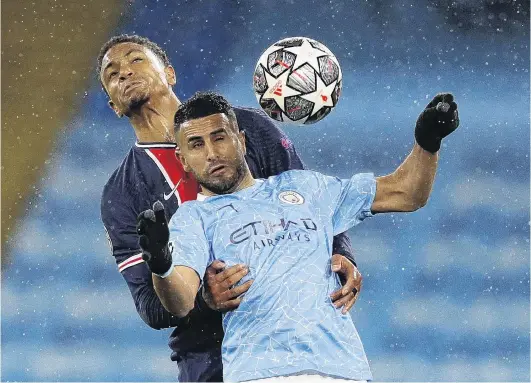  ?? PHOTO: REUTERS ?? No quarter given . . . Abdou Diallo, of Paris St Germain, clutches Manchester City’s Riyad Mahrez as they tussle for possession during their Champions League semifinal secondleg game in Manchester yesterday. Mahrez struck twice as his team advanced to the final.