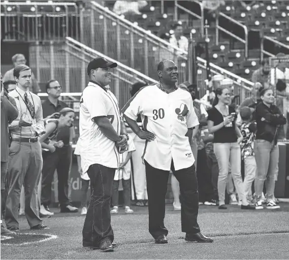  ?? TONI L. SANDYS/THE WASHINGTON POST ?? Ivan Rodriguez, left, and Tim Raines, were honoured by the Nationals on Monday night, but the history of the franchise complicate­s matters.