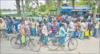  ?? PTI ?? ▪ People wait to check their names on the final draft of Assam National Register of Citizens in Nagaon on Monday.
