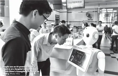 ?? Photo: VCG ?? People use an AI-powered robot to check in at a hospital in Guangzhou, South China’s Guangdong Province on April 3.