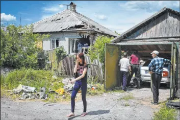  ?? Andriy Andriyenko The Associated Press ?? Residents remove debris Wednesday from a destroyed house after Russian shelling in Kramatorsk, Ukraine. Russian rockets pounded towns far from the front line.