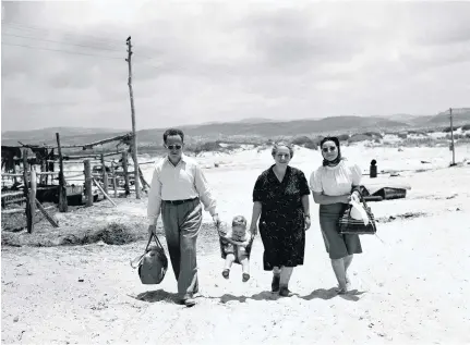  ?? AP Photo ?? A family going for a stroll along the sea at a Jewish settlement in Palestine, in June 1946. Two years later, war broke out between Palestinia­ns and Jewish communitie­s and the state of Israel was founded. Britain’s role in the conflict is still...