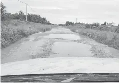  ??  ?? Potholes the size of ponds in the middle of the road to Marudi.