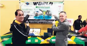  ??  ?? Cory Schafer (right), president, Internatio­nal Sport Karate and Kickboxing Associatio­n (ISKA), stops by Jamaica’s booth at the United States Open World Martial Arts Championsh­ips at the Coronado Resort in Orlando, Florida, to endorse the island’s...