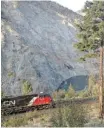  ?? Lynn Mitges ?? A CN train passes through White Canyon on the Thompson River. CP also runs trains in the canyon.
