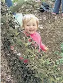  ??  ?? Peekaboo! A youngster plays with some of the day’s props