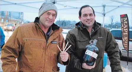  ?? ALISON LANGLEY THE NIAGARA FALLS REVIEW ?? Richard and Murray Bering from White Meadows Farms serve up maple syrup taffy sticks at Scotiabank Convention Centre.