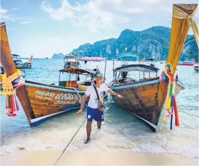  ?? Pictures: AFP ?? DAZZLING. Long tail boats moored on a beach on Phi Phi Don island in the Andaman Sea. The Thai holiday islands was made famous by Leonardo DiCaprio’s movie The Beach and are facing a severe water shortage, following a blistering heatwave across Asia.