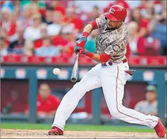  ?? [GARY LANDERS/THE ASSOCIATED PRESS] ?? The Reds’ Billy Hamilton hits an RBI single in the fifth inning.