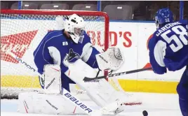  ?? DAVID CROMPTON/Penticton Herald ?? Michael DiPietro, a 2017 third-round pick of the Vancouver Canucks, makes a save during the Canucks’ first practice on Thursday at the South Okanagan Events Centre ahead of the annual Young Stars Classic tournament today through Monday at the SOEC.