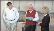  ?? Doug Walker / RN-T ?? Richard B. Russell Regional Airport Commission Chairman Chip Hood (from left), Earl Tillman and Floyd County Commission Chairwoman Rhonda Wallace share a laugh during a special called meeting of the two panels Tuesday to name a road at the airport Earl...